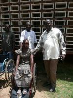Beneficiary Kadiatu has a new wheelchair with comfort footrest and 4 cushion for her work as a hairdresser